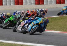 John Hopkins (21) leading Valentino Rossi, Randy de Puniet (14), Toni Elias (24), Colin Edwards (5), Nicky Hayden (1), and Marco Melandri (33) in MotoGP at Catalunya, 2007. Photo by DPPI Media.