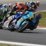 John Hopkins (21) leading Valentino Rossi, Randy de Puniet (14), Toni Elias (24), Colin Edwards (5), Nicky Hayden (1), and Marco Melandri (33) in MotoGP at Catalunya, 2007. Photo by DPPI Media.