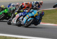 John Hopkins (21) leading Valentino Rossi, Randy de Puniet (14), Toni Elias (24), Colin Edwards (5), Nicky Hayden (1), and Marco Melandri (33) in MotoGP at Catalunya, 2007. Photo by DPPI Media.