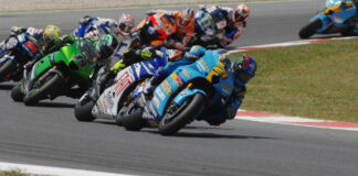 John Hopkins (21) leading Valentino Rossi, Randy de Puniet (14), Toni Elias (24), Colin Edwards (5), Nicky Hayden (1), and Marco Melandri (33) in MotoGP at Catalunya, 2007. Photo by DPPI Media.