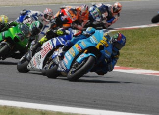 John Hopkins (21) leading Valentino Rossi, Randy de Puniet (14), Toni Elias (24), Colin Edwards (5), Nicky Hayden (1), and Marco Melandri (33) in MotoGP at Catalunya, 2007. Photo by DPPI Media.