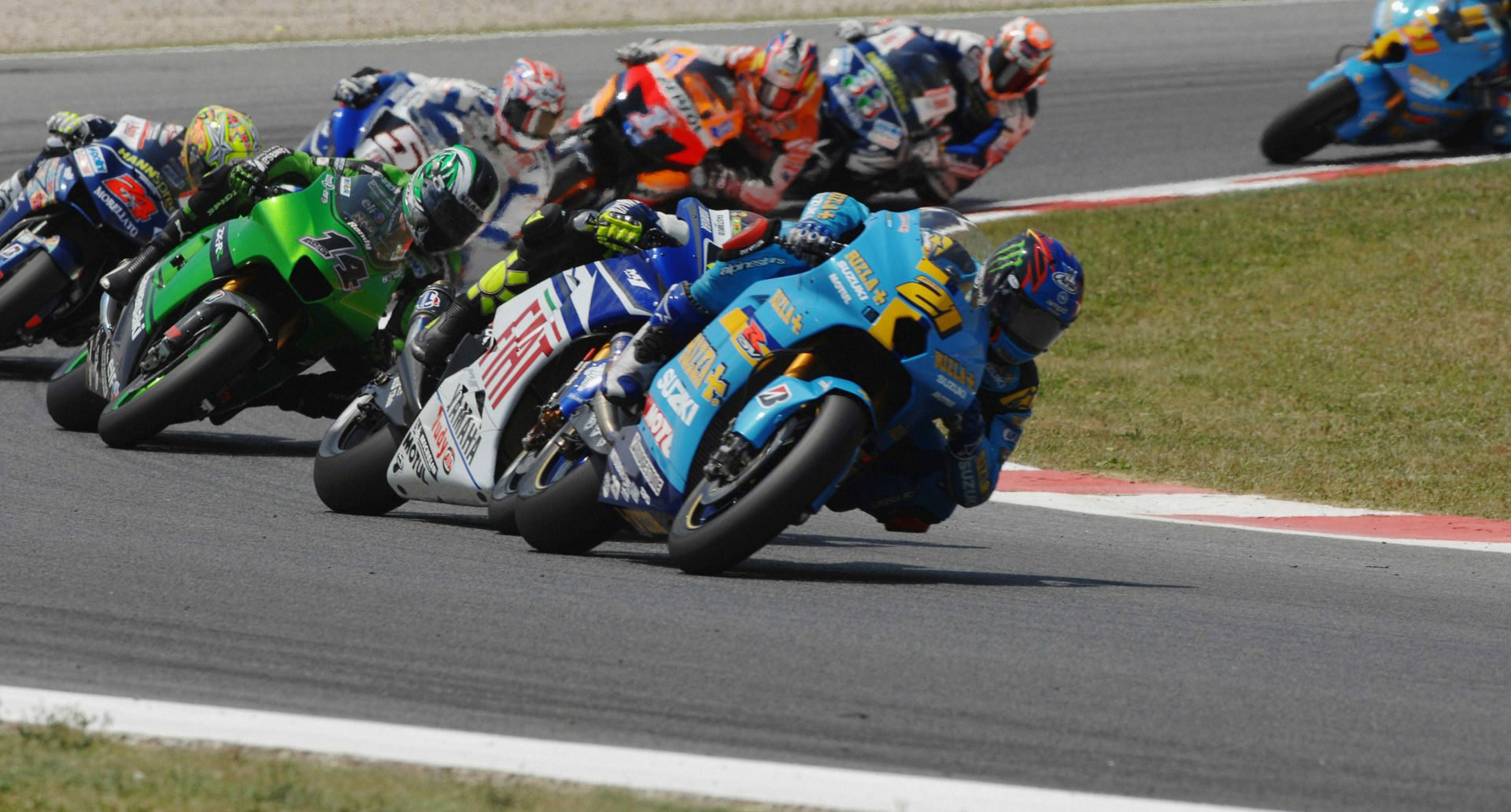 John Hopkins (21) leading Valentino Rossi, Randy de Puniet (14), Toni Elias (24), Colin Edwards (5), Nicky Hayden (1), and Marco Melandri (33) in MotoGP at Catalunya, 2007. Photo by DPPI Media.