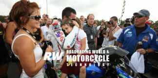 With then-wife Janine (far left) looking on, Mat Mladin embraces his two young daughters after finishing second in AMA Pro America Superbike Race Two at New Jersey Motorsports Park in 2009. It was Mladin's final AMA Superbike race before retiring. Photo by Brian J. Nelson.