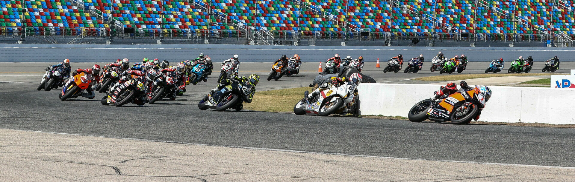 The original start of the 81st Daytona 200 with Josh Herrin (1) leading Danny Eslick (69), PJ Jacobsen (66), Richie Escalante (54), Tyler Scott (70), Geoff May (99), and the rest through Turn One. Photo by Brian J. Nelson.