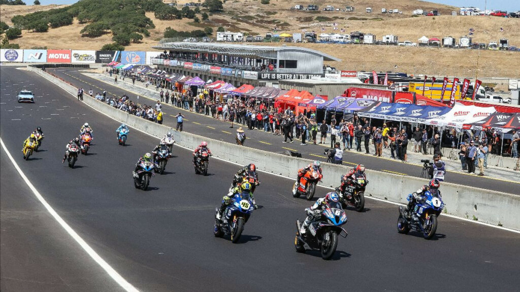 Cameron Beaubier (6) leads the way over Jake Gagne (1), Cameron Petersen (45), Richie Escalante (54), and the rest off the start of Saturday's Medallia Superbike race at WeatherTech Raceway Laguna Seca. The race was red-flagged when Petersen crashed and Beaubier struck his bike and also crashed.Photo by Brian J. Nelson.