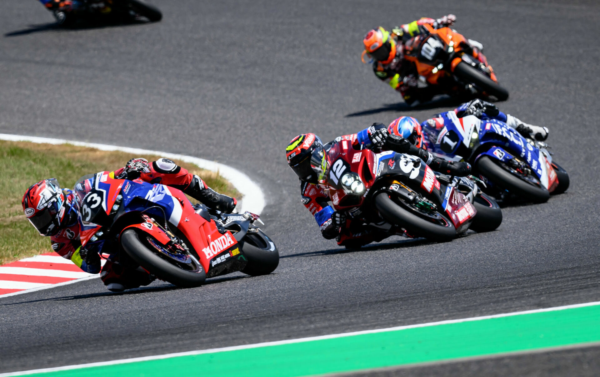 TOHO Racing (104), seen here trailing Team HRC with Japan Post (33), Yoshimura SERT Motul (12), and F.C.C. TSR Honda France (1) in the lead group early in the Suzuka 8-Hours race, has been disqualified from second place. Photo by Kohei Hirota.