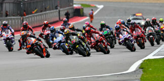 The start of the MotoGP race at Silverstone with Marco Bezzecchi (72) and Jack Miller (43) contesting the lead. Photo courtesy Dorna.