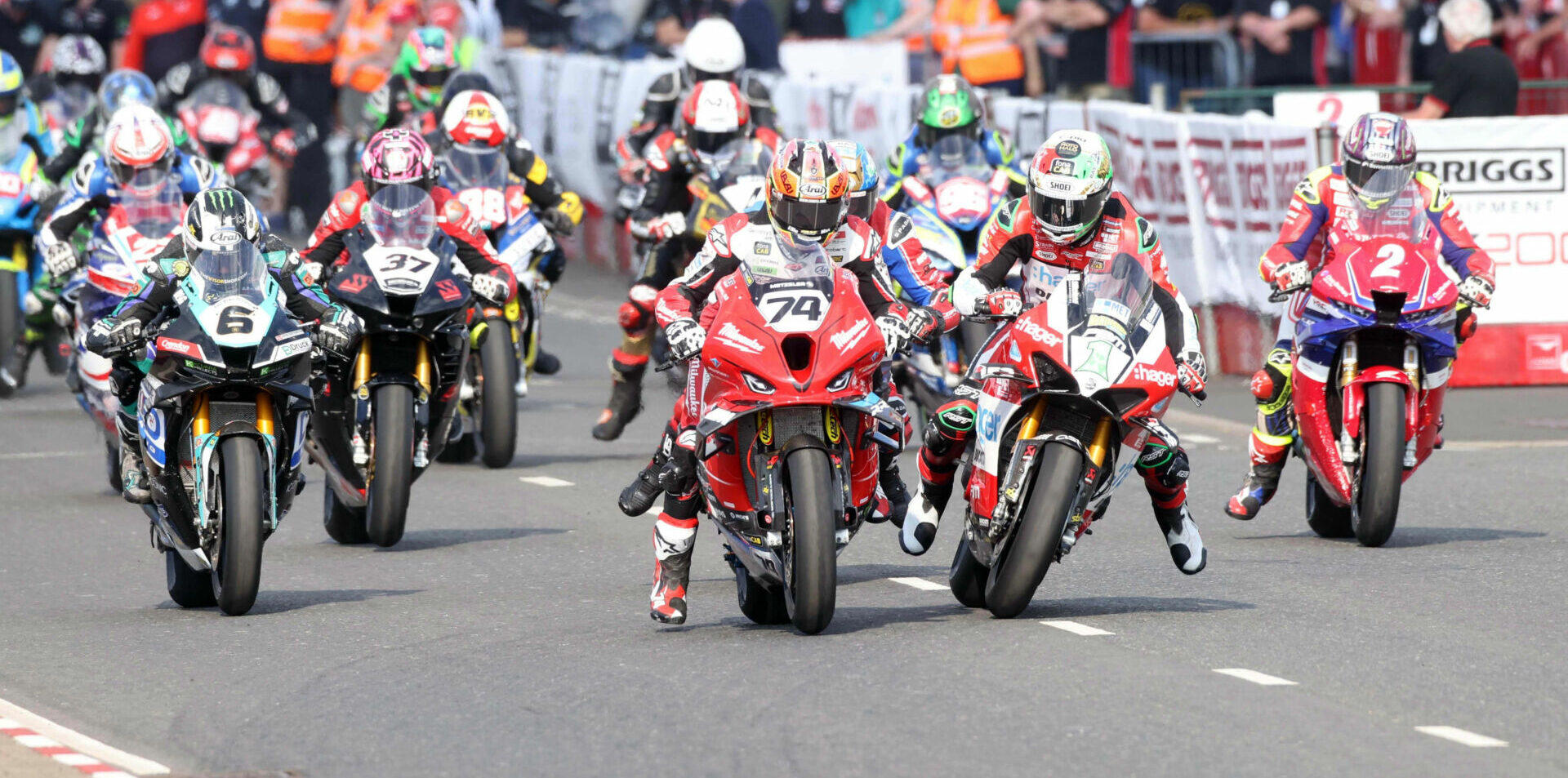 Glenn Irwin (1) and Davey Todd (74) nearly touch as they launch off the grid at the North West 200. Photo courtesy NW200 Press Office.
