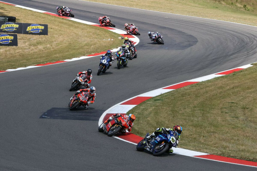 Cameron Petersen (45) leads Josh Herrin (2). Loris Baz (76), Bobby Fong (50) and the rest of the Steel Commander Superbike field on the opening lap at Ridge Motorsports Park. Photo by Brian J. Nelson.