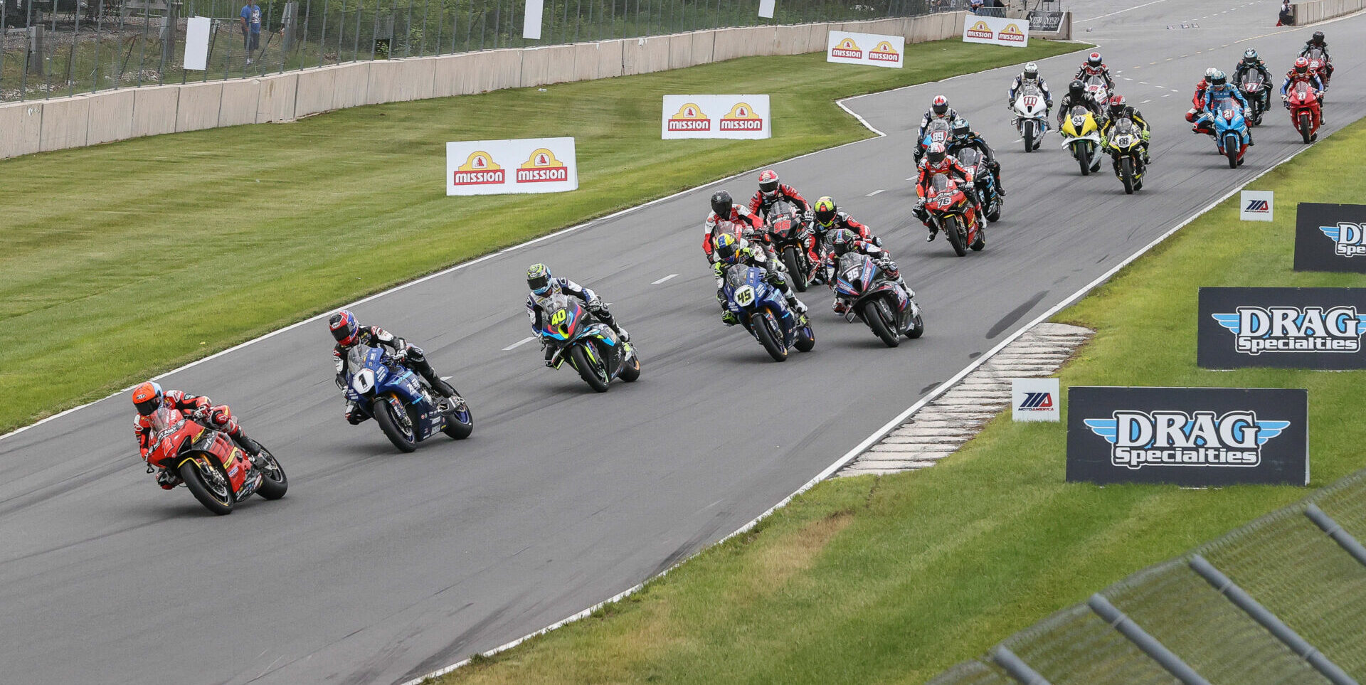 The start of MotoAmerica Superbike Race Two with Josh Herrin (2) leading Jake Gagne (1), Sean Dylan Kelly (40), Cameron Petersen (45), JD Beach (95), and the rest of the field into Turn One. Photo by Brian J. Nelson.