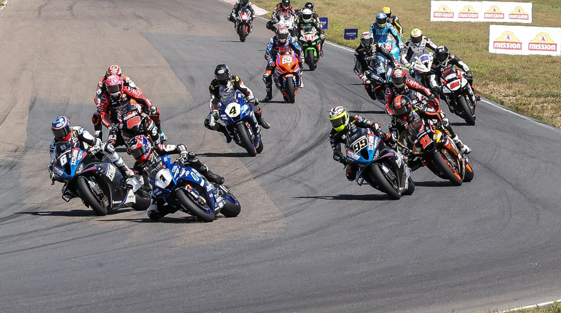 The start of MotoAmerica Superbike Race One at Brainerd in 2023, seconds before Cameron Beaubier (6) set off a chain-reaction crash that affected Jake Gagne (1), PJ Jacobsen (99), Mathew Scholtz (11), and their Championship aspirations. Photo by Brian J. Nelson.