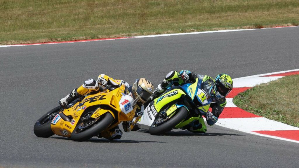 Supersport race winner Mathew Scholtz (11) battles PJ Jacobsen (15) in Sunday's race. The two made contact a few laps from the end with Jacobsen crashing out. Photo by Brian J. Nelson.