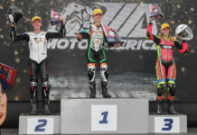 Avery Dreher, 17, (left) and Ella Dreher, 14, (right), when they made history by both finishing on the MotoAmerica Junior Cup podium at Brainerd. Matthew Chapin (center) won the rain-shortened race. Photo by Brian J. Nelson.