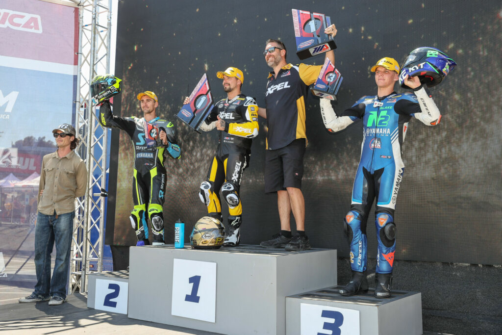 Joe Roberts (far left) handed out the trophies to Mathew Scholtz second from left), PJ Jacobsen (center) and Blake Davis (far right) on the Supersport podium at Laguna Seca. Photo by Brian J. Nelson.