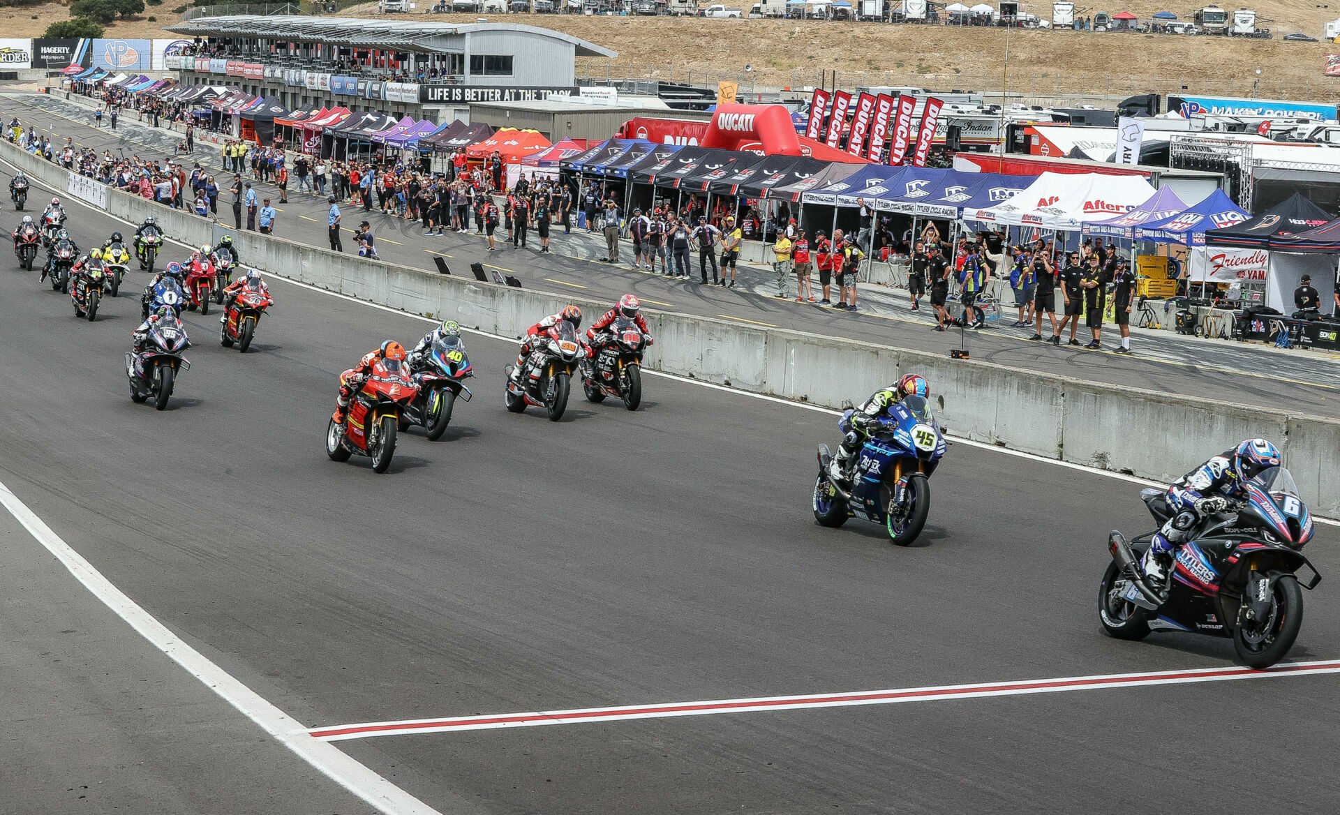 Cameron Beaubier (6) leads the start of MotoAmerica Superbike Race One at WeatherTech Raceway Laguna Seca in July 2023. Photo by Brian J. Nelson.