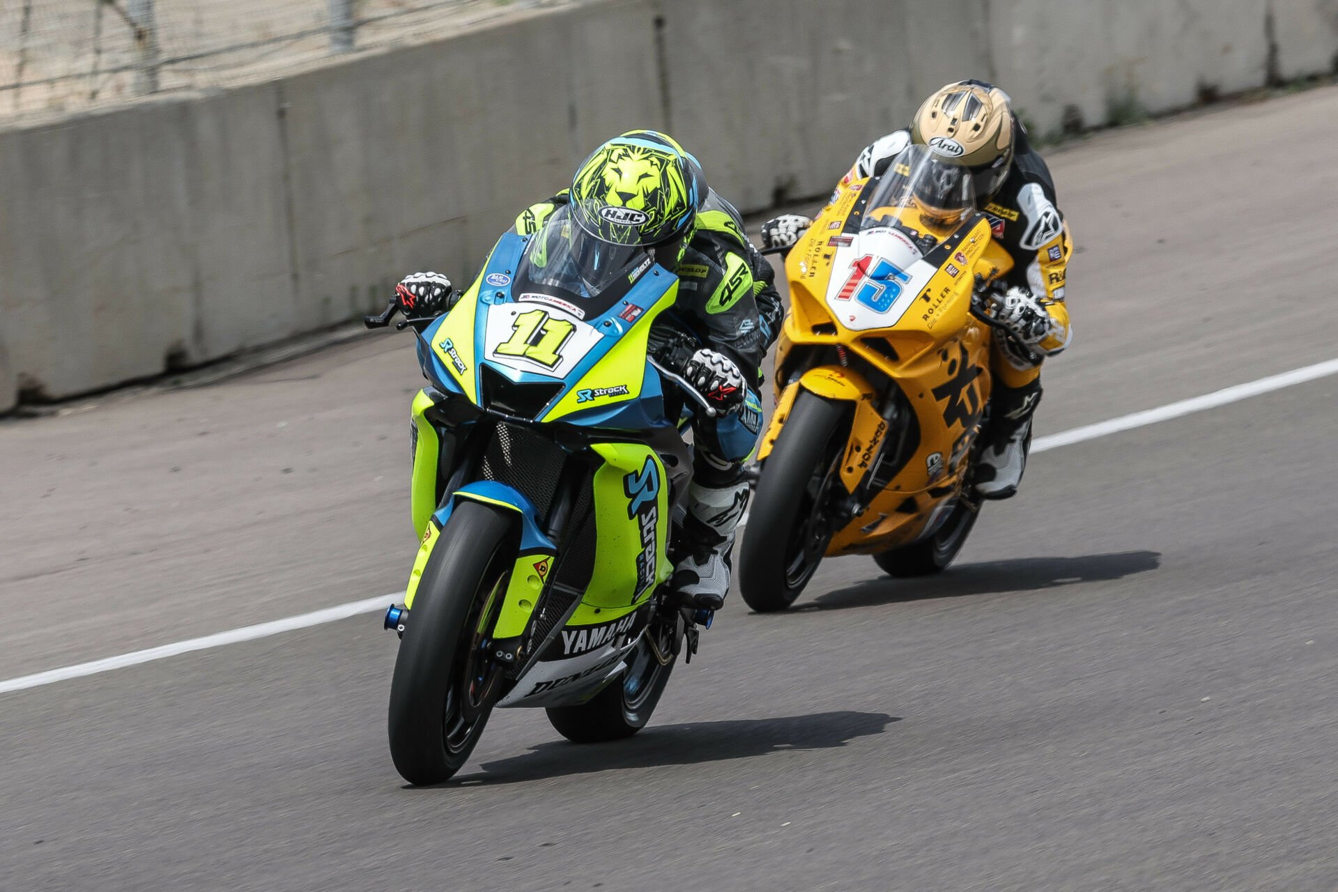 This is what the 2024 MotoAmerica Supersport Series looks like: Mathew Scholtz (11) vs. PJ Jacobsen (15) going back and forth in their private battle for the championship. Photo by Brian J. Nelson, courtesy MotoAmerica.