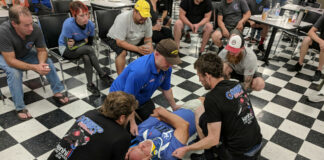 A mock crash patient has his head and neck stabilized with a brace in a first aid drill at a Carters@theTrack event. Photo courtesy Clive Savacool.