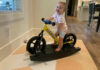 Olivia Grace "OG" Barnes and her Strider balance bike on its rocker base. Photo by Anne Barnes.