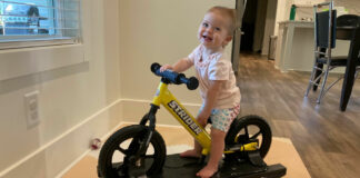 Olivia Grace "OG" Barnes and her Strider balance bike on its rocker base. Photo by Anne Barnes.