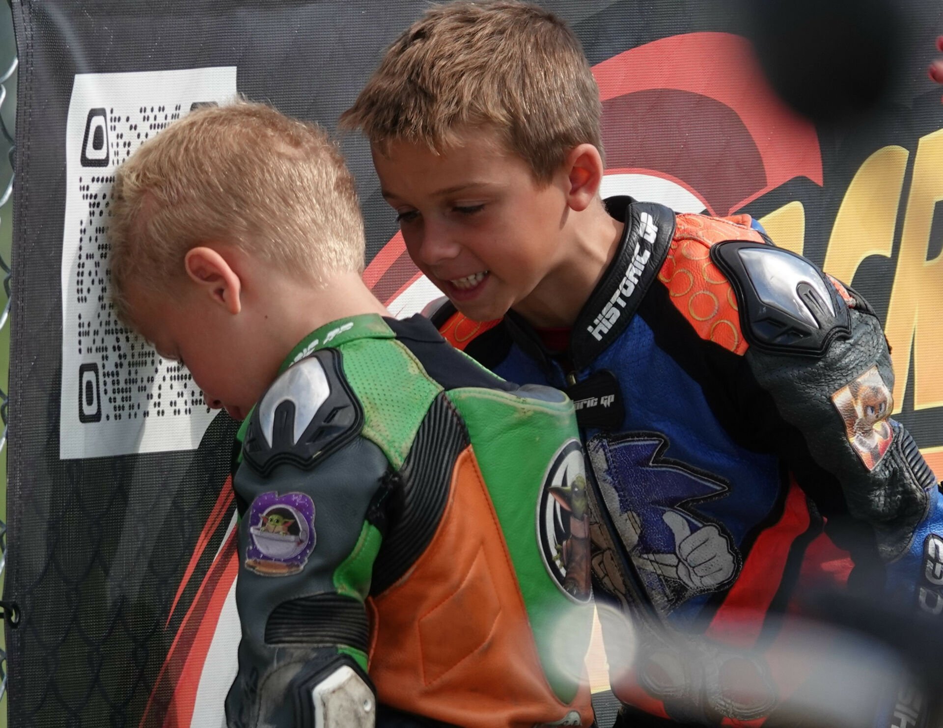 Chase Jazikoff (right) tries to cheer up his little brother Cooper (left) after Stock 50 race two on Saturday. Cooper challenged his big brother for the lead, but a mistake in the closing laps dropped him out of contention. Photo by Larry Lawrence, courtesy MotoAmerica.