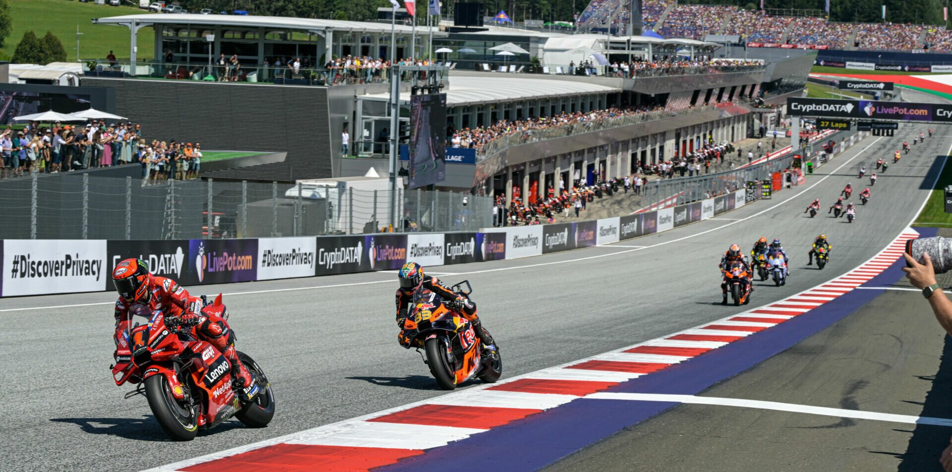 Francesco Bagnaia (1) leading Brad Binder (33) during the MotoGP race in Austria in 2023. Photo courtesy Dorna.