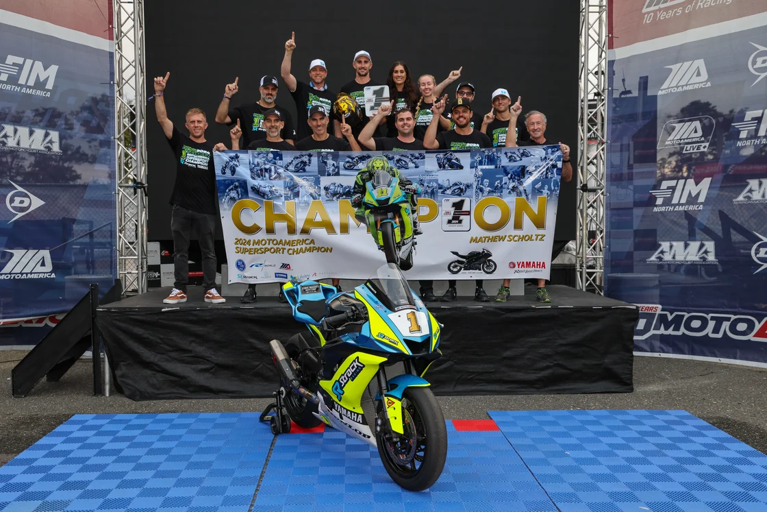 The Strack Racing team and supporters pose with 2024 MotoAmerica Supersport Champion Mathew Scholtz.