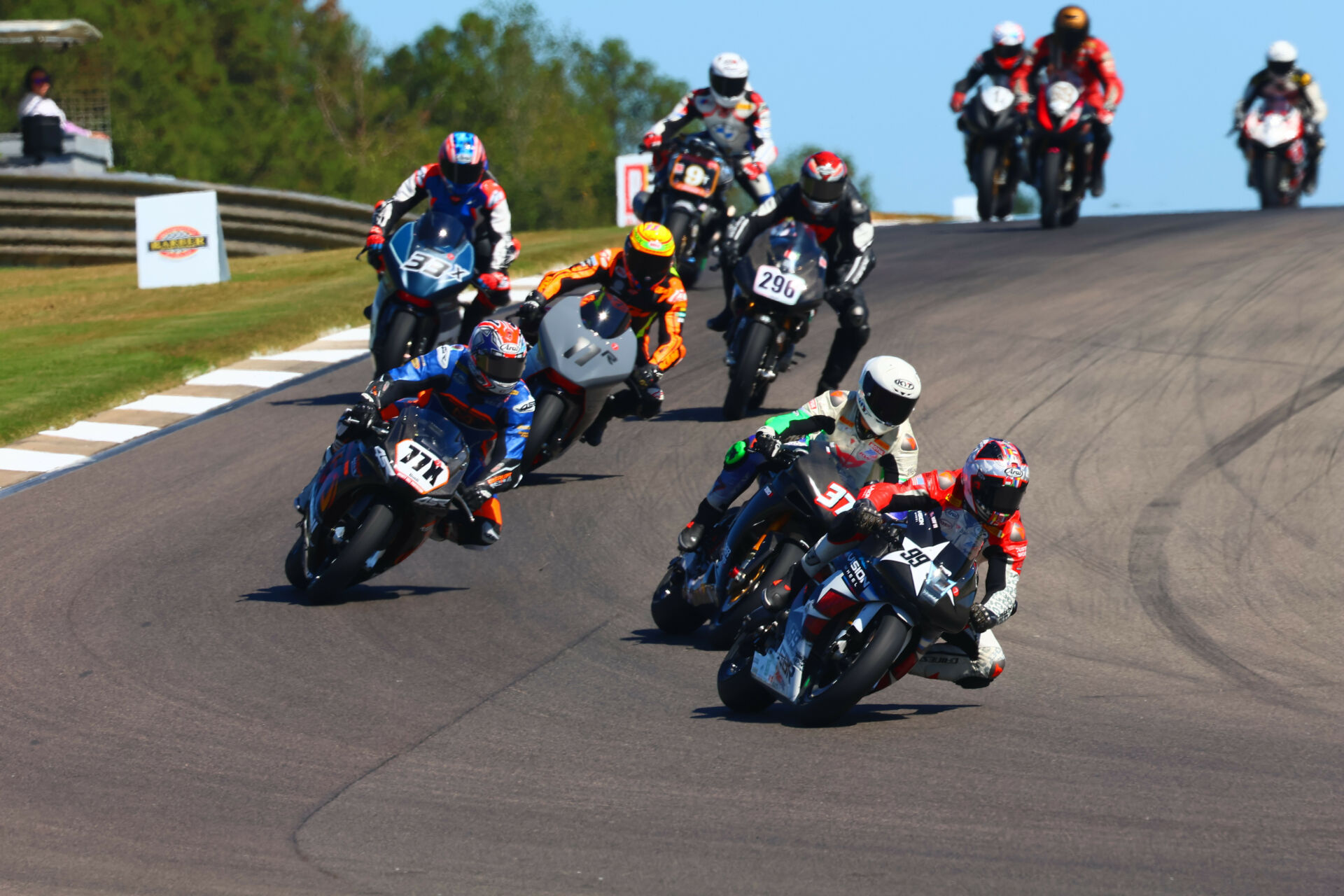 Geoff May (99), Stefano Mesa (37), Hayden Gillim (77X), Chris Fillmore (11R), Rennie Scaysbrook (33X), Gus Rodio (296), and Nate Kern (9T) during the 2023 AHRMA Pro Challenge race. Photo by etechphoto.com, courtesy AHRMA.