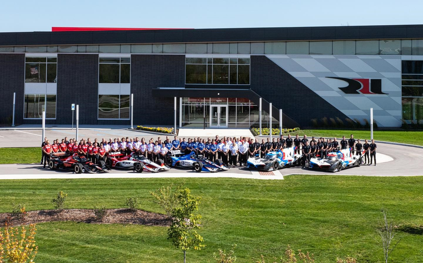 The Rahal Letterman Lanigan Racing teams pose in front of their race shop in Zionsville, Indiana, in 2023. Photo courtesy Rahal Letterman Lanigan Racing.