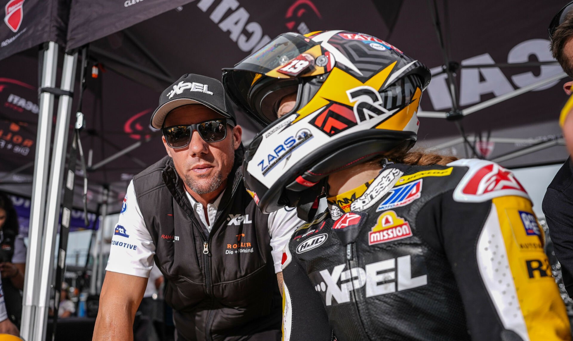 Rahal Ducati Moto Team Principal Ben Spies (left) talks with rider Kayla Yaakov (right) on pit wall at Mid-Ohio. Photo by Brian J. Nelson.