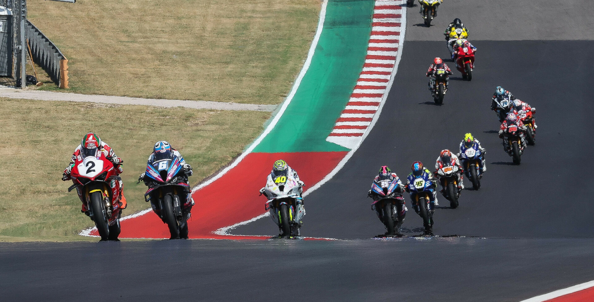 Josh Herrin (2) leads Cameron Beaubier (6), Sean Dylan Kelly (40), and the rest of the field at the start of MotoAmerica Superbike Race Three at COTA. Photo by Brian J. Nelson.