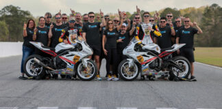 Michelle A. Lindsay (center) with husband Myles Wilson (to Lindsay's immediate right), riders Danny Eslick (left) and Brandon Paasch (right), and the rest of the TOBC Racing team ahead of the 2022 Daytona 200. Photo courtesy Triumph.