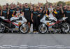 Michelle A. Lindsay (center) with husband Myles Wilson (to Lindsay's immediate right), riders Danny Eslick (left) and Brandon Paasch (right), and the rest of the TOBC Racing team ahead of the 2022 Daytona 200. Photo courtesy Triumph.