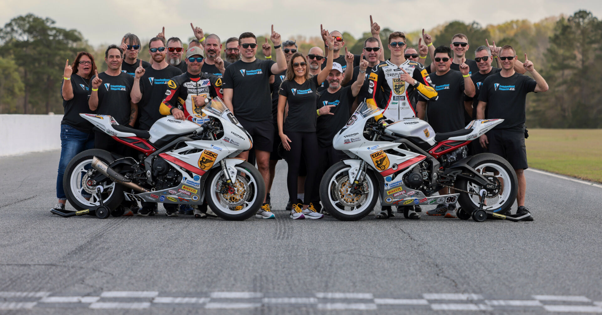 Michelle A. Lindsay (center) with husband Myles Wilson (to Lindsay's immediate right), riders Danny Eslick (left) and Brandon Paasch (right), and the rest of the TOBC Racing team ahead of the 2022 Daytona 200. Photo courtesy Triumph.