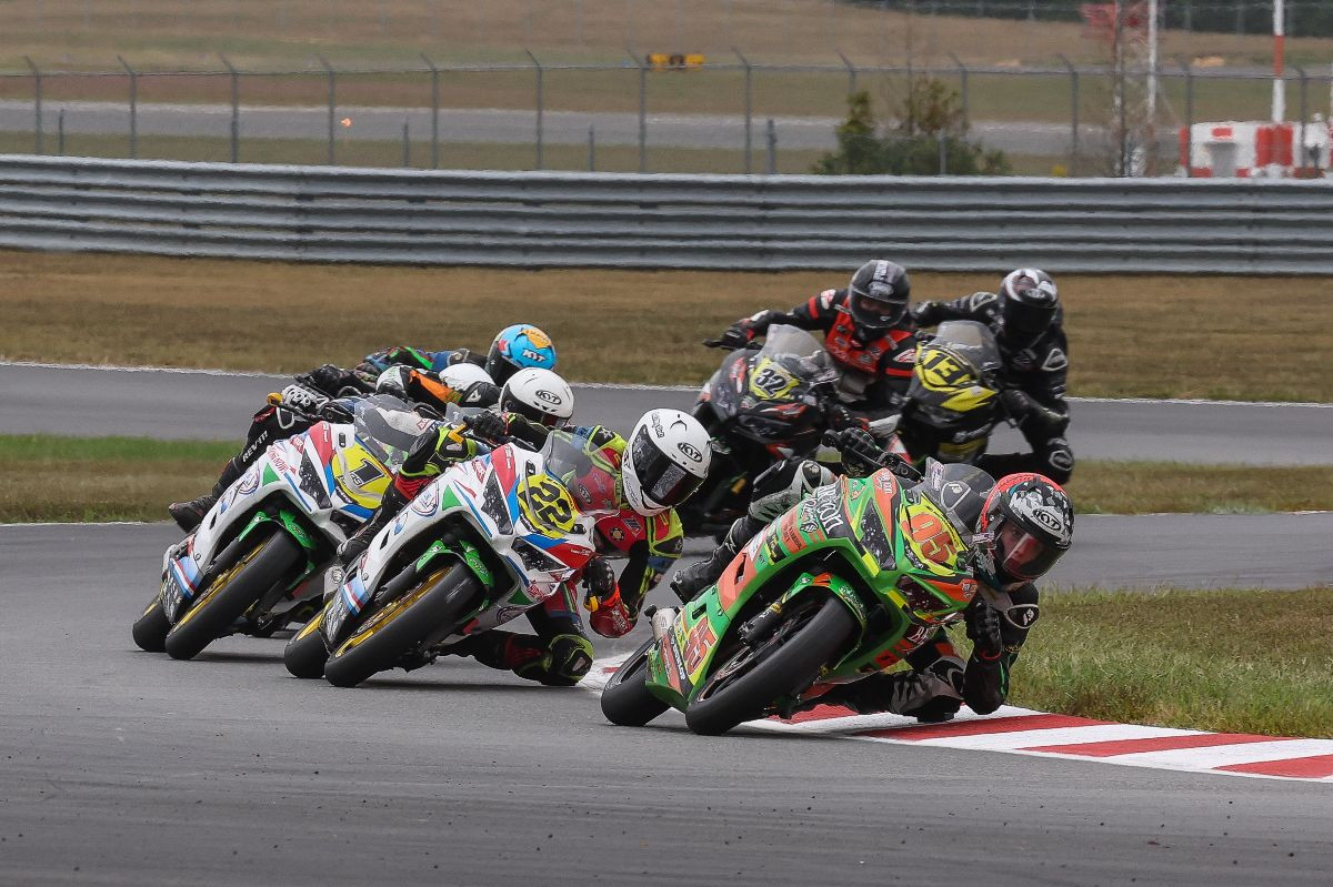 Mathew Chapin (95) leads Ella Dreher (22) and Avery Dreher (1) in their epic battle in Sunday's Junior Cup race at NJMP. Photo by Brian J. Nelson.