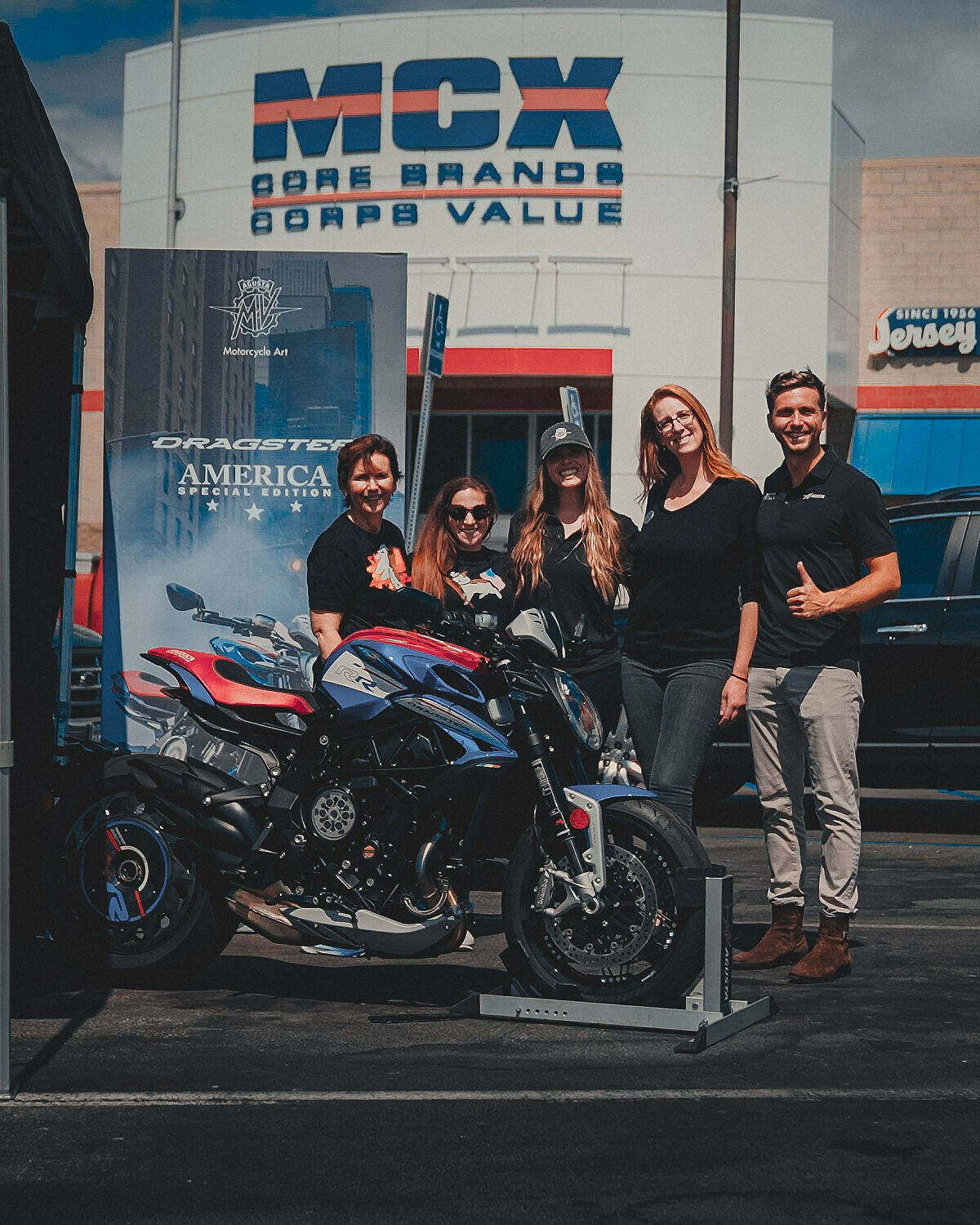 From left, MV Agusta North America Sales Manager Cindy Bashaw-Downing; Corporate Sales-Marketing Executive Stephanie Sancedo; Marketing Manager Olivia Goheen; Corporate Sales-Marketing Executive Misty Breymeyer, and General Manager Luca Dovesi pose with the MV Agusta Dragster RR SCS America donated to a drawing held at Camp Pendleton Marine Base. Cpl. Kimo Malott won the drawing.