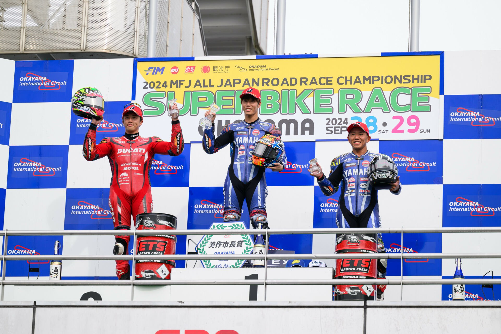 Superbike Race podium with Ryo Mizuno (on the left), Yuki Okamoto (in the middle) and Katsuyuki Nakasuga (on the right). 