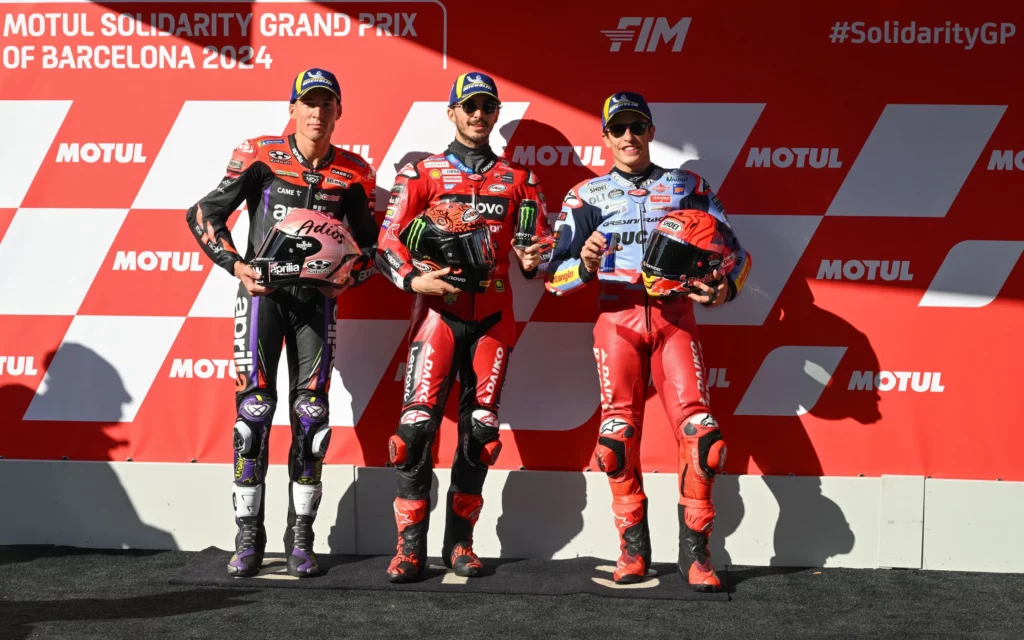 First row picture with Alex Espargaro (on the left), Francesco Bagnaia (in the middle) and Marc Marquez (on the right). Photo courtesy Dorna. 